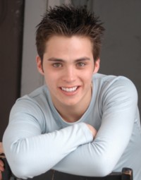 prt_whiteshirt_backwardchair_smile_200w.jpg